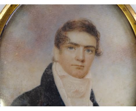 An early 19th century miniature watercolour on ivory, half length portrait of a gentleman, unsigned, height 8.5cm, brass fram