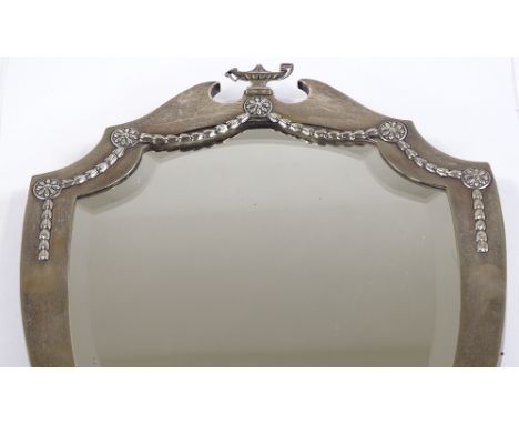 An Edwardian large silver-fronted shield-shaped mirror, with cup finial and silver foliate swags, by Walker &amp; Hall, hallm