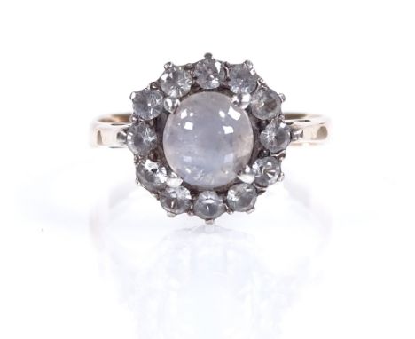 An unusual cabochon star sapphire and white sapphire cluster ring, unmarked gold settings, setting height 11.3mm, size K, 2.7