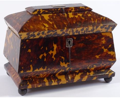 A 19th century tortoiseshell sacophagus tea caddy, tortoiseshell inner lids resting on ball feet, one foot missing and small 
