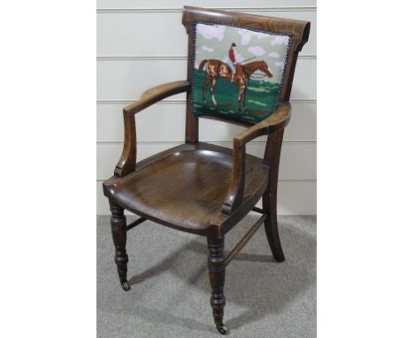 A Victorian oak desk elbow chair, with tapestry upholstered back 