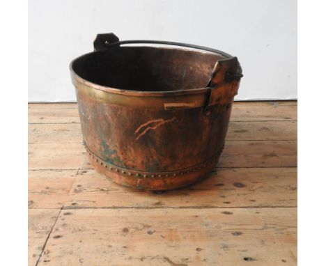 A VINTAGE POLISHED COPPER RIVETED BUCKET WITH IRON RING HANDLE, 48cm dia, 32cm deep 