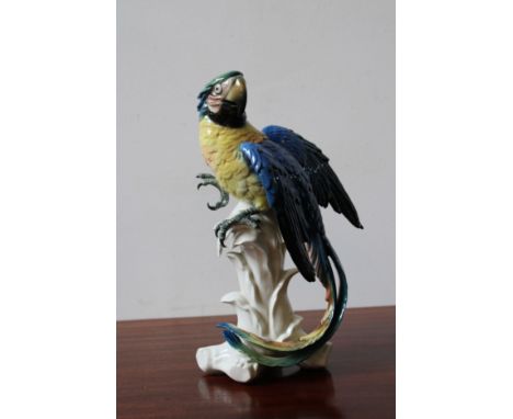 A KARL ENS CERAMIC FIGURE OF PARROT ON LEAFY PERCH, 32.5cm high 