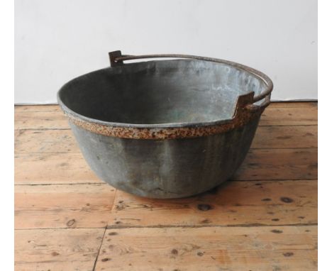A VINTAGE DISTRESSED COPPER PAN WITH IRON RING HANDLE, 59cm dia x 28cm deep 
