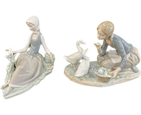Two vintage Lladro figurines one girl feeding geese, the other a girl petting a dove, overall height of tallest approximately