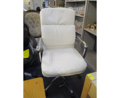 A modern cream leather upholstered swivel office chair, together with a light wood desk having two inset drawers 
