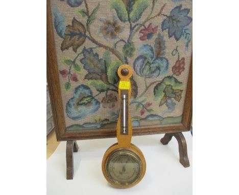 A maple cased barometer and a firescreen 