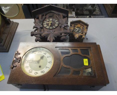 Two cuckoo clocks, together with a 1930s oak wall hanging clock 