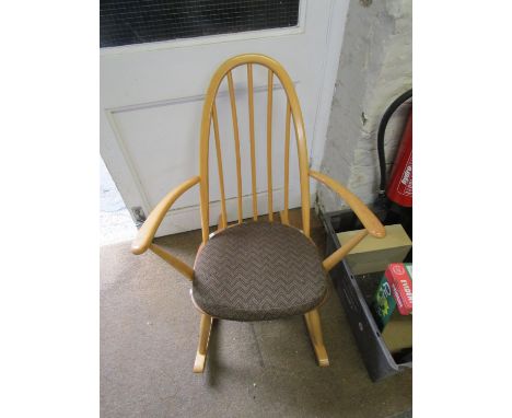 An Ercol beech spindle back rocking armchair 