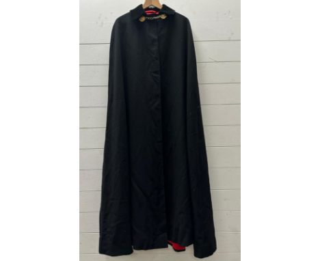 A black ambassadors cloak by London tailors Gieves and Hawkes with a black velvet colour along with a Harrods green velvet Be