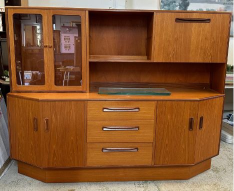 A G-Plan Mid Century sideboard with glazed cupboard and drop down drinks cabinet over and three central drawers flanked by tw