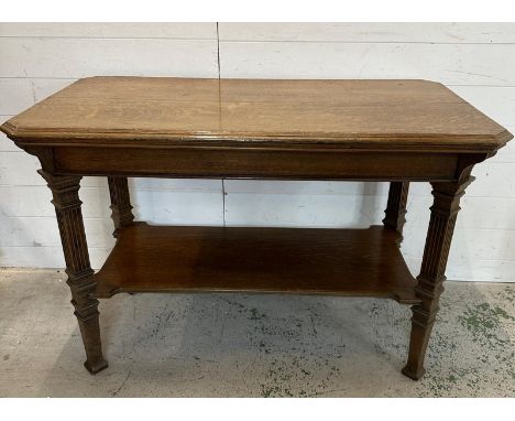 An oak side console table on reeded legs and shelf under (H76cm W115cm D62cm)
