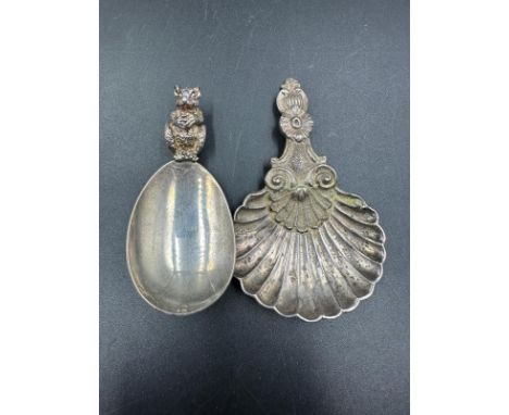 Two caddy spoons, one hallmarked silver for London and the other shell style in white metal.