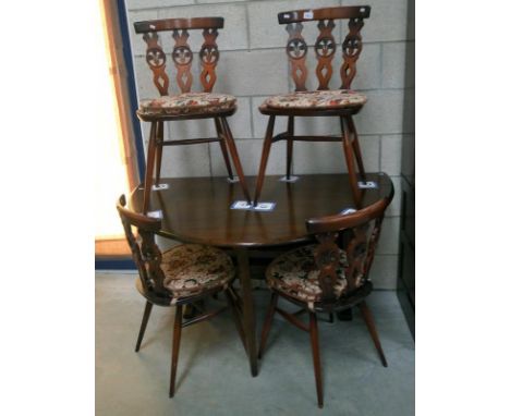 An Ercol oak drop leaf table and 4 dining chairs