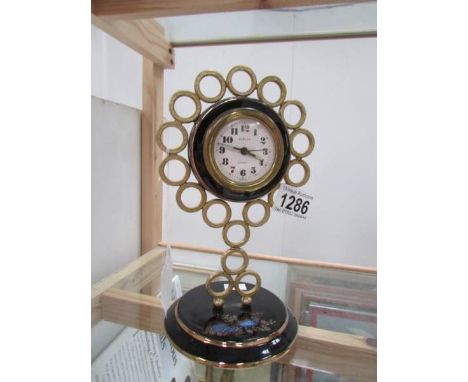 An enamel and brass clock marked Europa, 2 jewel, Germany