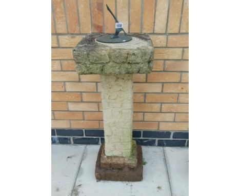 A sundial on concrete plinth