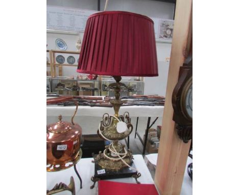 An ornate table lamp with shade