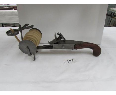 A Victorian flintlock pistol tinder box table lighter with wax candle roll