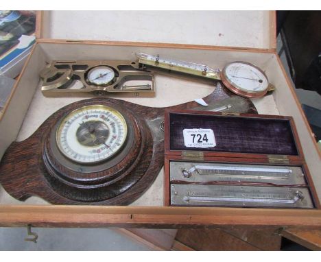 A box containing scientific instruments including Inclinometer, max/min thermometers, barometer and polymeter etc