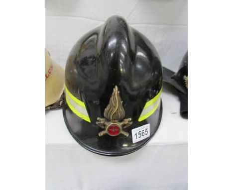An old fireman's helmet with flame emblem