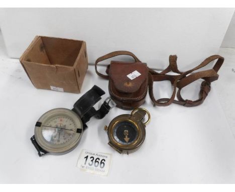 A military compass with case and an old wrist compass