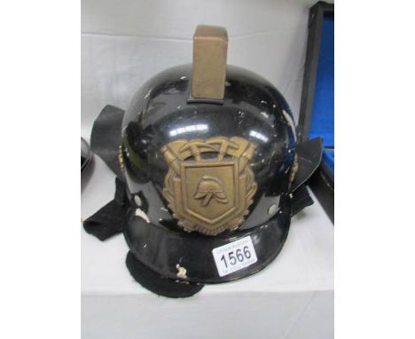 A fireman's helmet with brass emblem