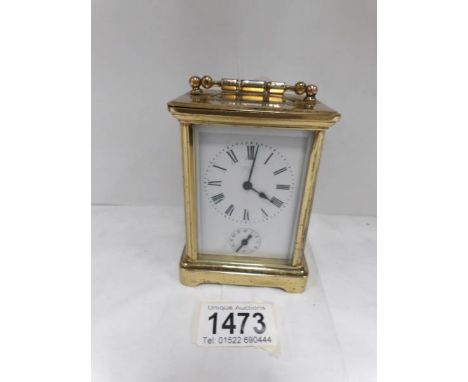An old brass carriage alarm clock in working order, makers name faded