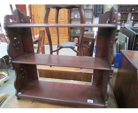 A mahogany hanging wall shelf