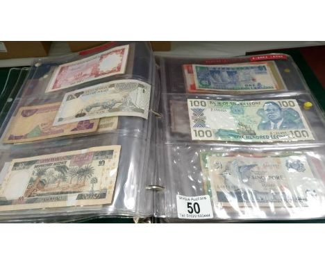 A folder of approximately 86 world bank notes, countries R - T