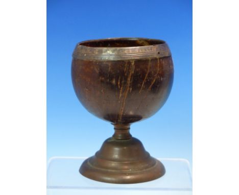 A COCONUT CUP WITH WHITE METAL RIM AND SUPPORTED ON STEPPED CIRCULAR COPPER FOOT. H 13cms.