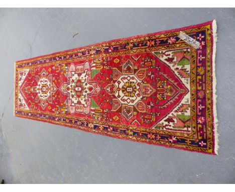 A PERSIAN TRIBAL RUNNER.  312 x 96cms.