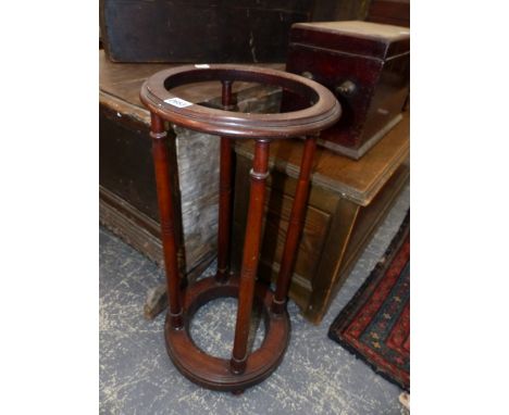 A 19th C. MAHOGANY STICK STAND, THE RING TOP SUPPORTED ON FOUR COLUMNS FLARING TO THE CIRCULAR BASE ON FOUR BUN FEET.   Dia 3