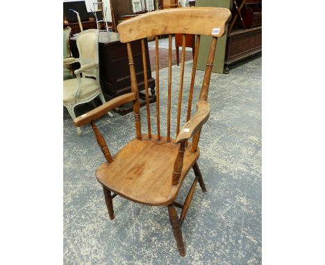 AN OAK AND ASH ARMCHAIR WITH A BROAD TOP RAIL OVER A STICK BACK, THE SOLID SEAT ABOVE TURNED LEGS.