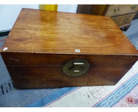 A CHINESE HARDWOOD TRUNK WITH BRASS HANDLES AND CIRCULAR LOCK PLATE.   W 95 x D 62 x H 44.5cms.