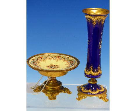 A FLORAL ENAMELLED ROYAL BLUE GROUND WAISTED CYLINDRICAL VASE ON FOUR ORMOLU FEET.   H 15cms. ROGETHER WITH A YELLOW GROUND E