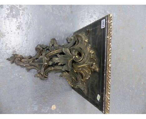 A CARVED WOOD AND GESSO ROCOCO FOLIAGE SUPPORTED SQUARE WALL BRACKET, NOW PAINTED BLACK WITH GILT HIGHLIGHTS.   H 41 x W 34 x