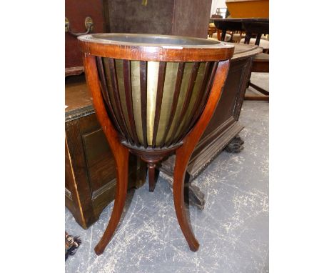 AN EDWARDIAN BRASS LINED MAHOGANY PLANTER WITH STRAP SIDES BELOW THE CIRCULAR TOP AND ON THREE SQUARE SECTIONED CABRIOLE LEGS
