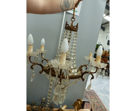 A SIX LIGHT GILT METAL AND CRYSTAL CHANDELIER IN THE FRENCH TASTE, TOGETHER WITH TWO FOLIATE FORM SCONCES AND A GLASS LAMP.