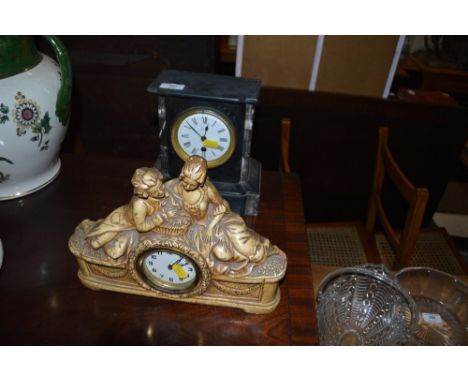 A late Victorian black slate mantel clock  AF; and a plaster mantel clock mounted with two figures 