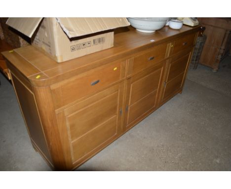 A large modern light oak sideboard fitted three drawers 
