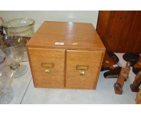 A light oak table top two drawer filing chest 