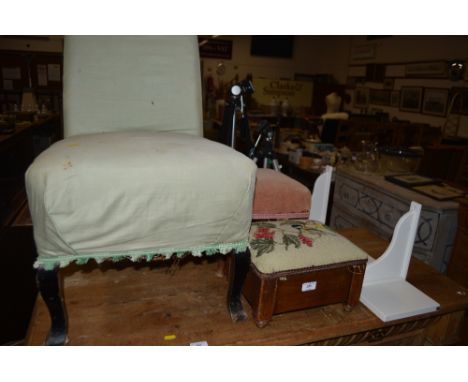 A green upholstered nursing chair; two footstools; and a wall shelf 