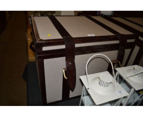 A modern leather bound storage trunk 