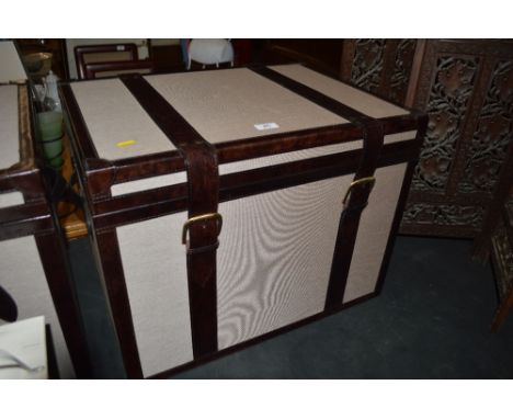 A modern leather bound storage trunk 