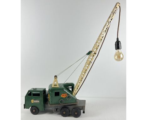 A green and cream vintage tin plate 6 wheel Marx and Co "Lumar Contractors" High Lift Mobile crane adapted into a table lamp.