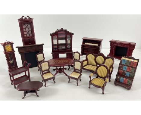 A collection of 1:12 scale dark wood dolls house furniture. To include mirror backed bookcase, piano and stool bookcase with 