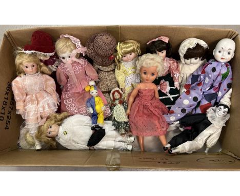 A collection of 12 porcelain dolls to include Pierrot dolls. Together with a vintage vinyl doll with blonde hair.