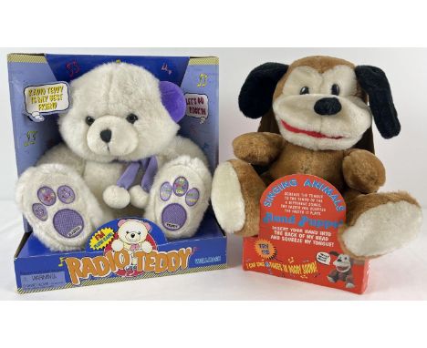 2 boxed battery operated plush bear toys. A 2001 Wellmark Radio Teddy together with a singing animal hand puppet. 