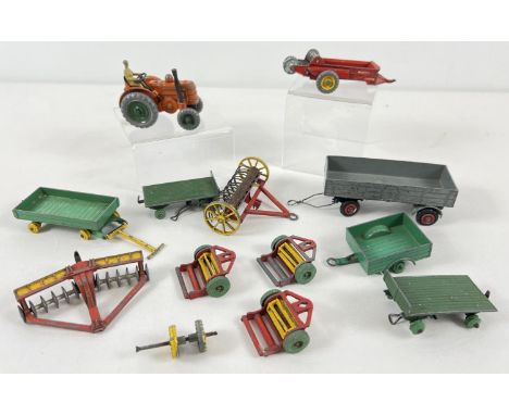 A collection of assorted vintage Dinky Toys diecast farm machinery &amp; equipment. To include: #301 Field Marshall Tractor -