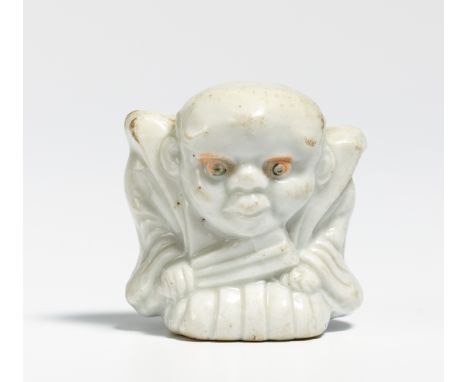 NETSUKE: THE LUCKY DWARF FUKUSUKE AS RAKUGO STORYTELLER.  Japan. 19th c.  Porcelain. H.3.7cm. Condition B.  Provenance:  Form